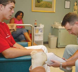Lower limb amputee with doctor getting examined.